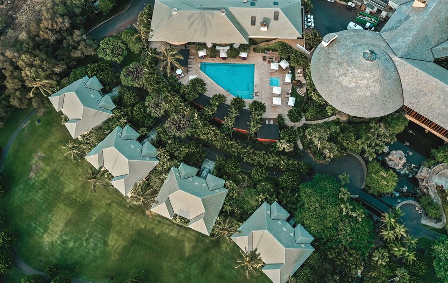 Aerial view of a tropical resort with a pool among gardens in Wailea, Maui